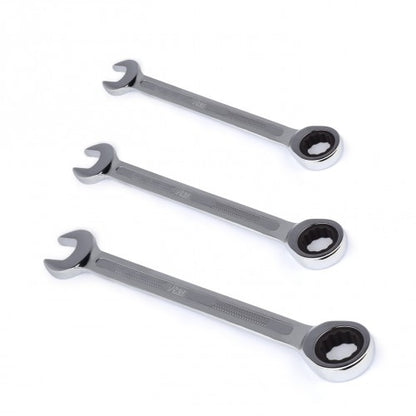 Three metallic ring spanners on a white background