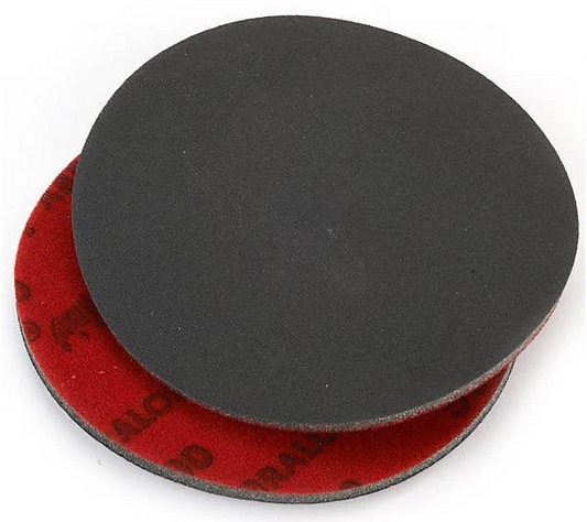 Black and red sanding disc on a white background