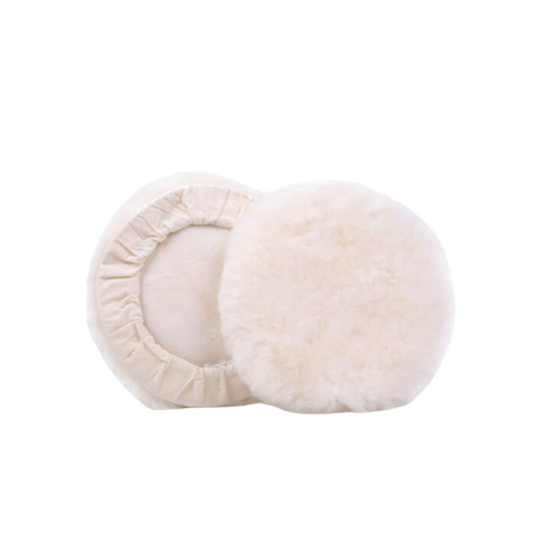 Two white wool pads stacked on top of each other, with a textured surface.